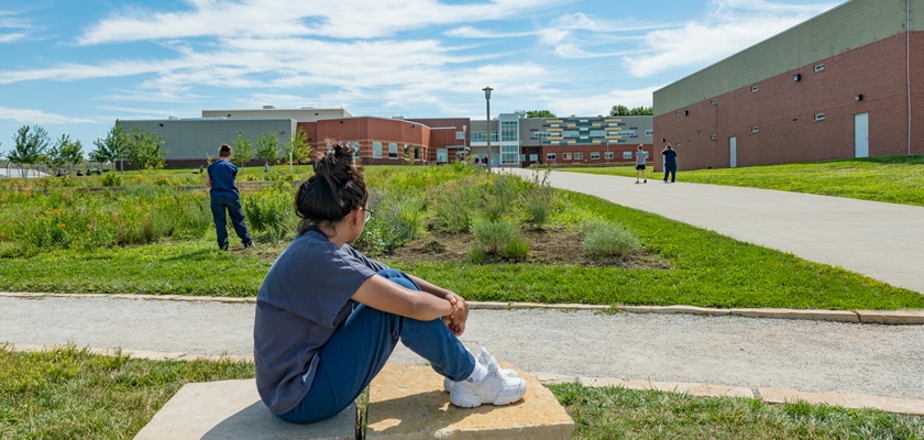 A woman sits in the garden at the Iowa Correctional Institution for Women