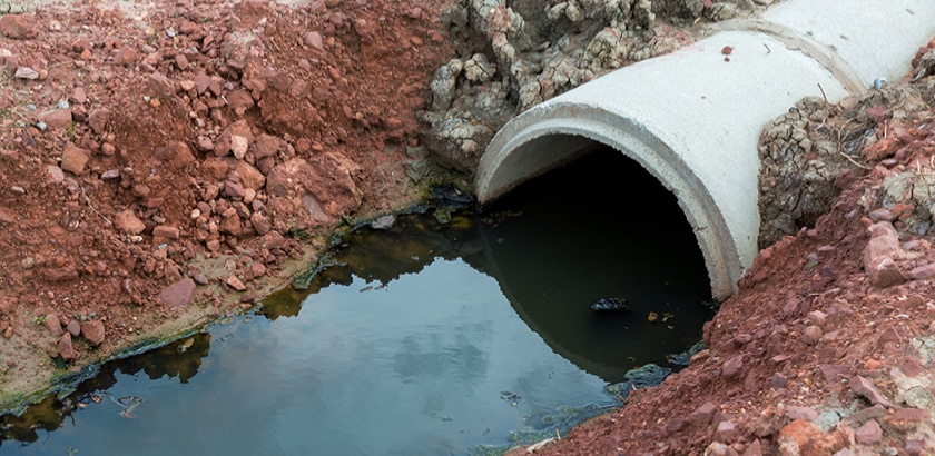 Concrete circular run-off pipe discharging water