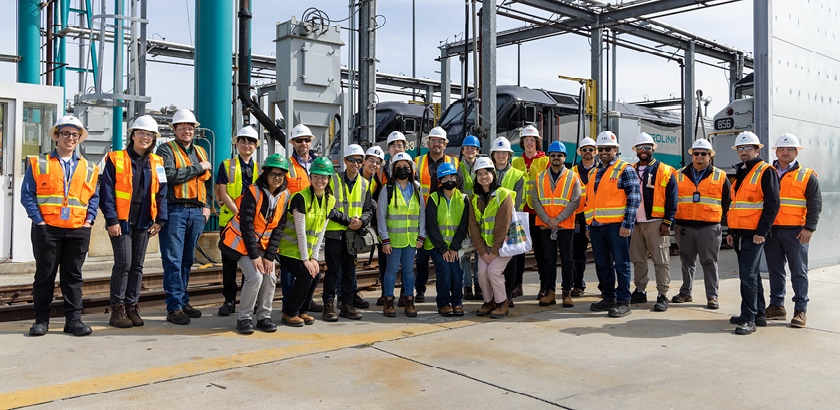 Group photo of people in construction hats and vests