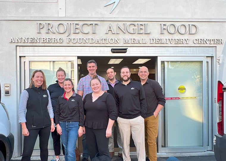 people standing in front of Project Angel Food building