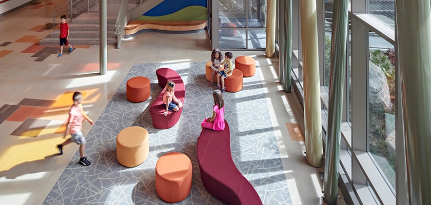 kids sitting on colorful seats in school